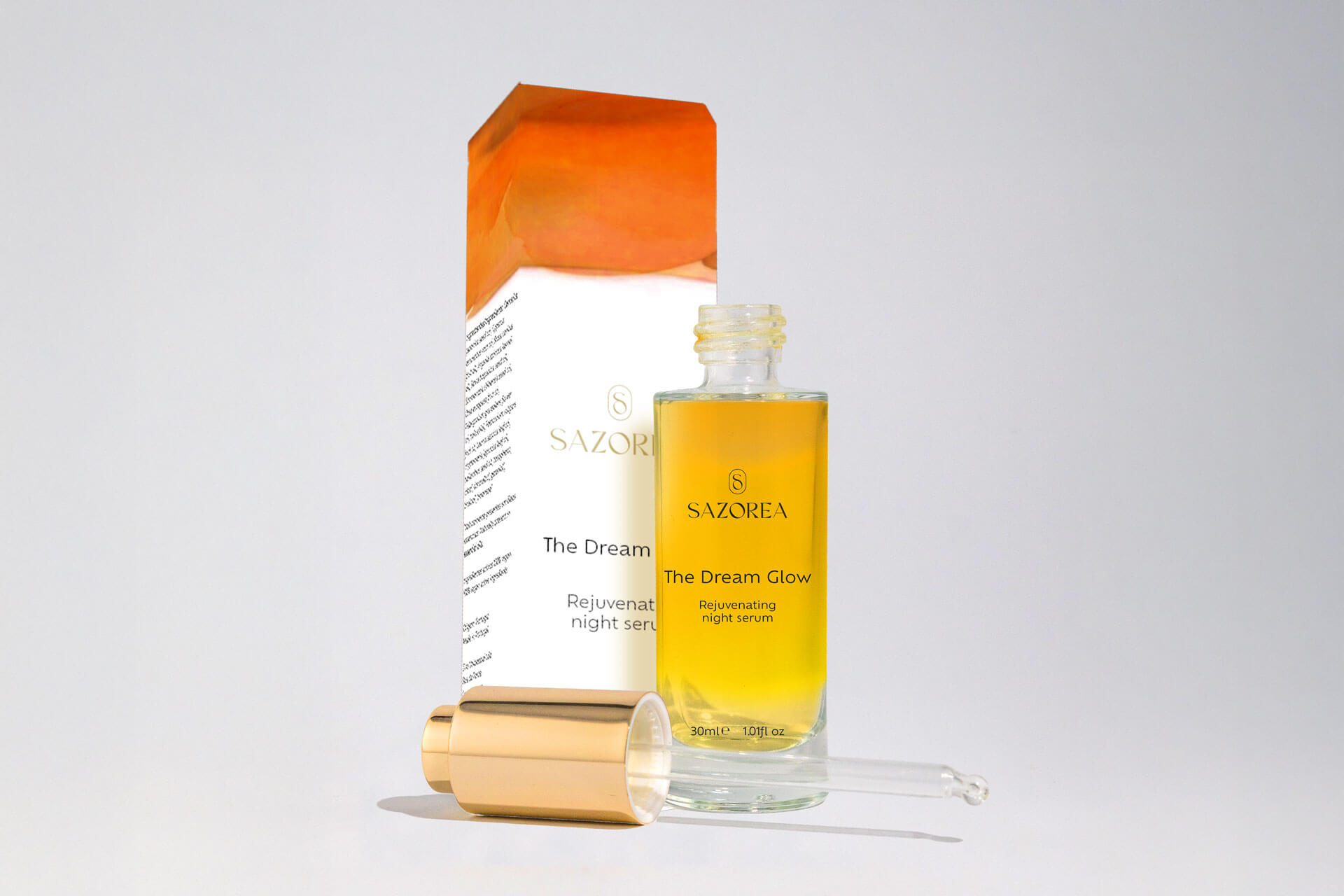 Embalagem The Dream Glow - óleo facial Sazorea com design laranja dourado
